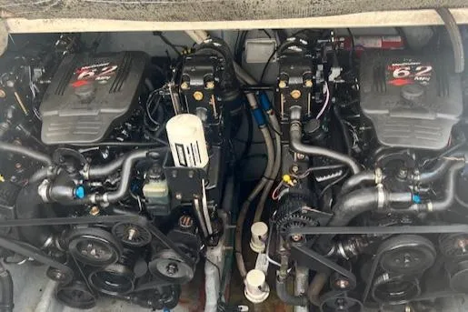 Slide: The Image of Twin engines of a 2003 Sea Ray 290 Amberjack boat, showcasing detailed mechanical components. - 24