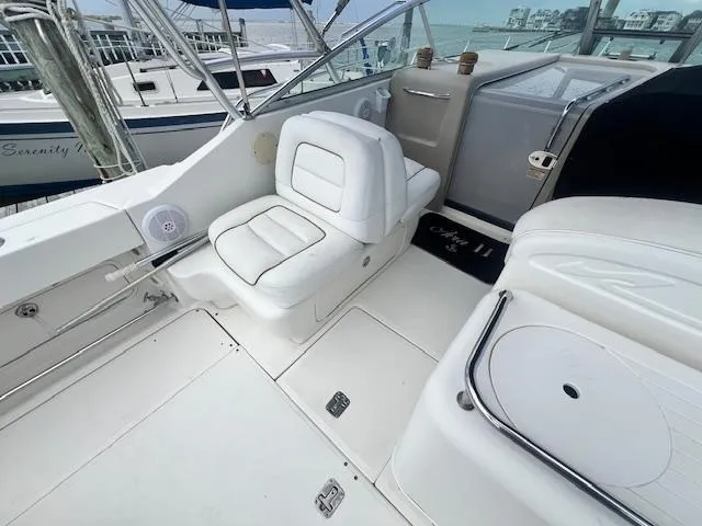 Slide: The Image of 2003 Sea Ray 290 Amberjack boat interior with white seating and helm area. - 7