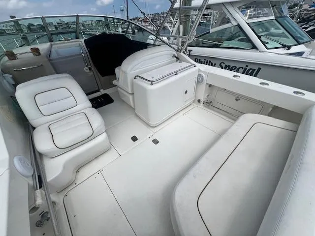 Slide: The Image of 2003 Sea Ray 290 Amberjack boat interior with white seating and helm. - 8