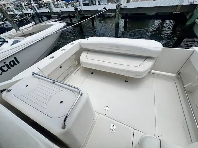Slide: The Image of 2003 Sea Ray 290 Amberjack boat deck with seating, docked at marina. - 9