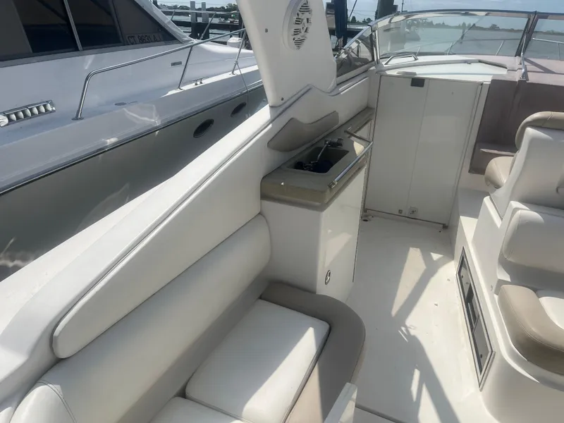 Slide: The Image of 2003 Regal 3260 Commodore boat interior with white seating and helm station. - 3