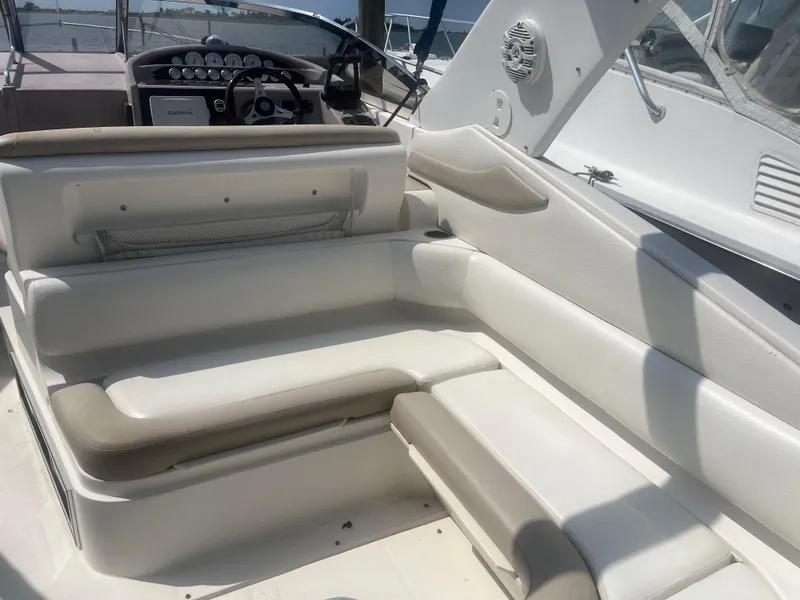 Slide: The Image of 2003 Regal 3260 Commodore boat interior with white seating and control panel. - 4