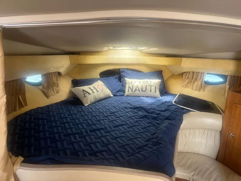 Slide: The Image of Cozy cabin interior of 2003 Regal 3260 Commodore with nautical-themed pillows. - 7