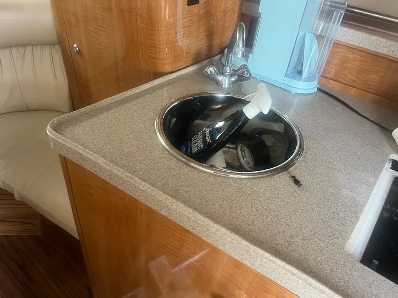 Slide: The Image of 2003 Regal 3260 Commodore boat interior with sink and cleaning supplies. - 8