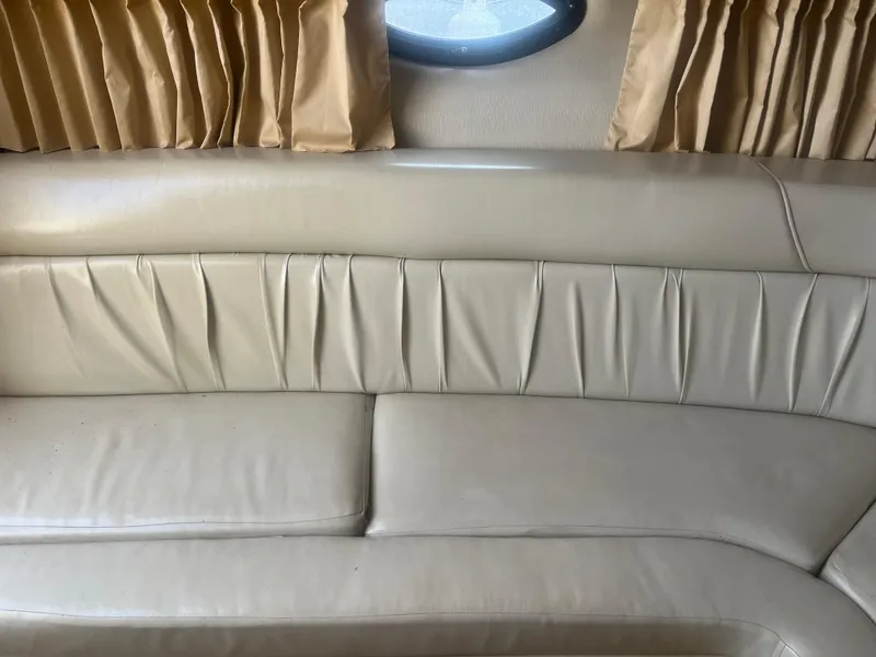 Slide: The Image of Interior of 2003 Regal 3260 Commodore with beige leather seating and curtains. - 9