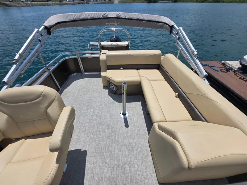 Slide: The Image of 2020 Avalon LSZ Cruise II pontoon boat with beige seating on a lake. - 10