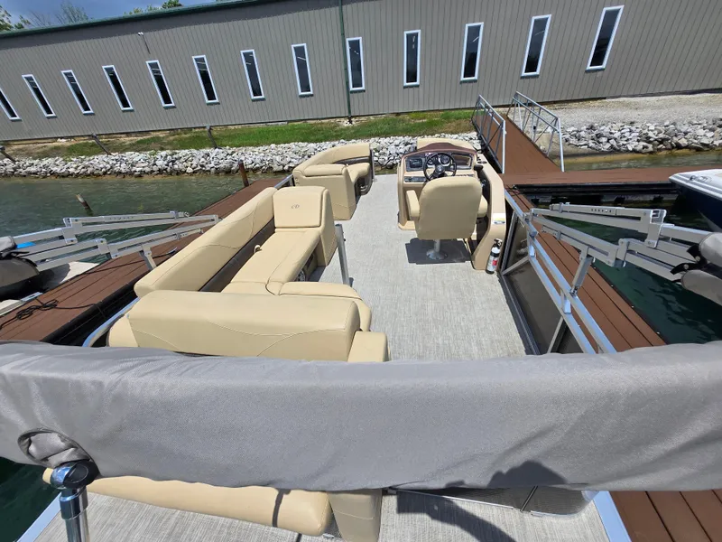 Slide: The Image of 2020 Avalon LSZ Cruise II 22' pontoon boat interior with beige seating at dock. - 14