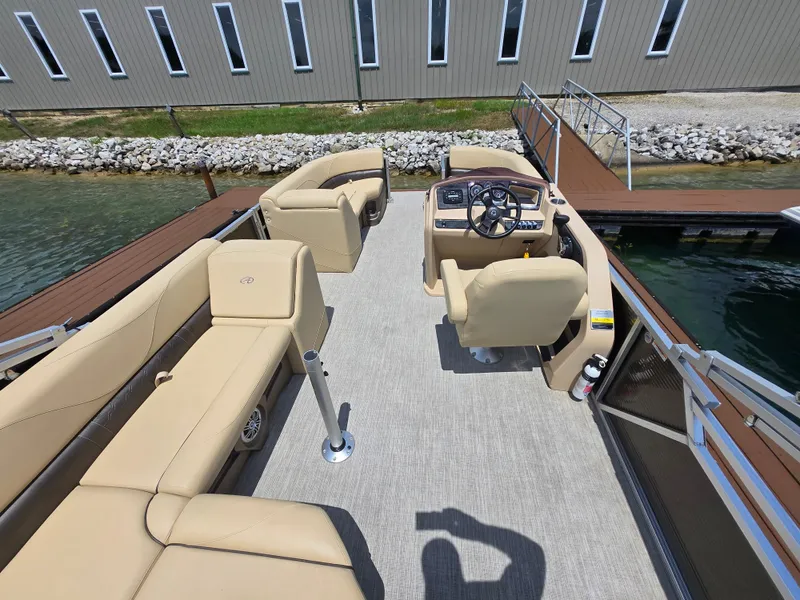 Slide: The Image of 2020 Avalon LSZ Cruise II pontoon boat interior with beige seating and steering console. - 16