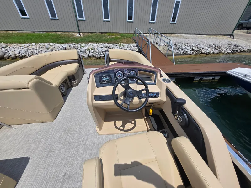 Slide: The Image of 2020 Avalon LSZ Cruise II boat interior with beige seating and steering console. - 17