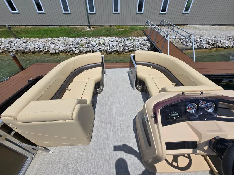 Slide: The Image of 2020 Avalon LSZ Cruise II pontoon boat interior with beige seating and control panel. - 19
