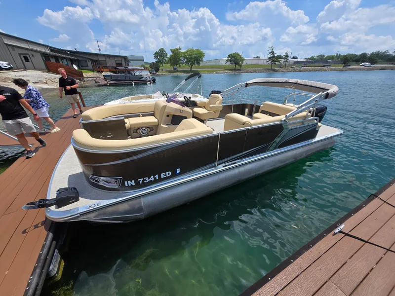 Slide: The Image of 2020 Avalon LSZ Cruise II pontoon boat docked on a sunny day. - 4