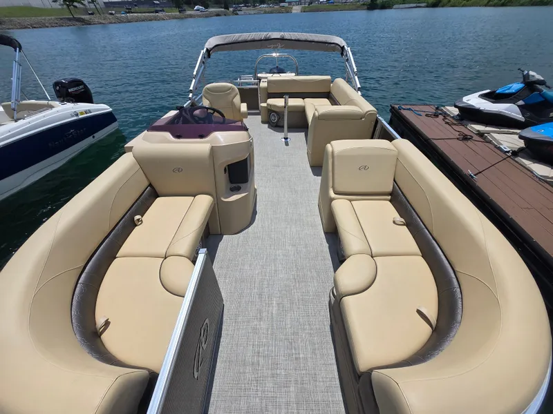 Slide: The Image of 2020 Avalon LSZ Cruise II pontoon boat with spacious seating on a calm lake. - 6