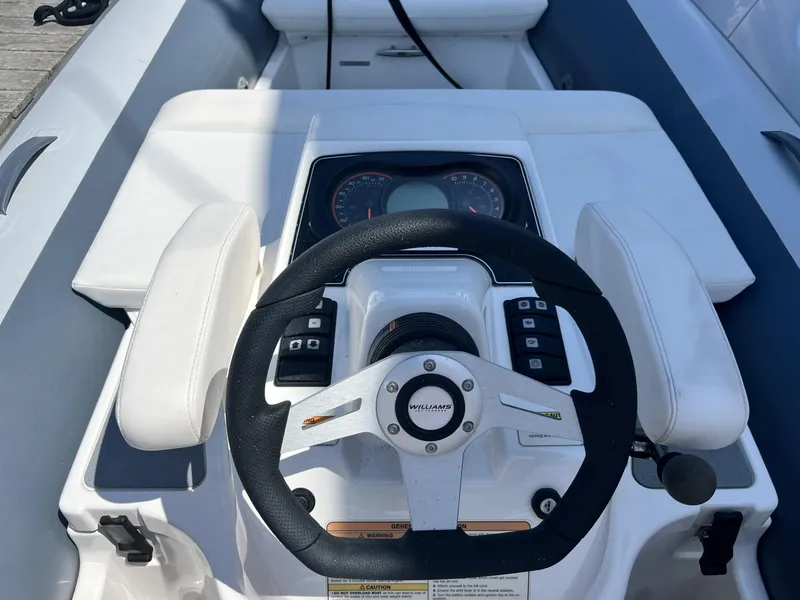 Slide: The Image of Steering console of a 2021 Williams Jet Tenders Turbojet 325 with control panel. - 10