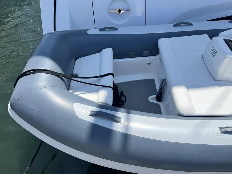 Slide: The Image of 2021 Williams Jet Tenders Turbojet 325, gray and white inflatable boat docked on water. - 13