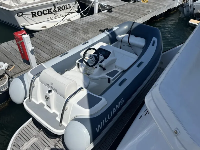 Slide: The Image of 2021 Williams Jet Tenders Turbojet 325 docked at marina, featuring sleek design and modern controls. - 3