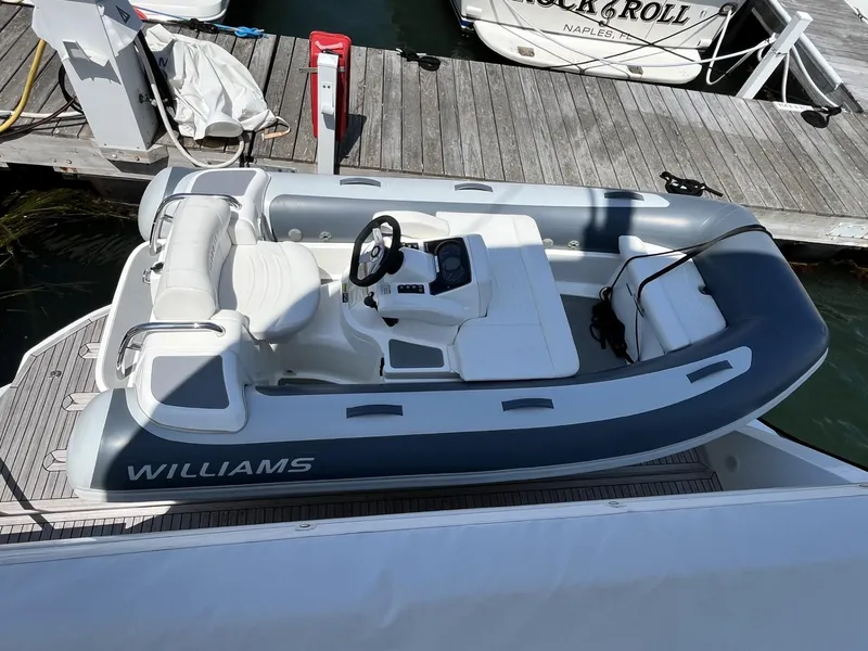 Slide: The Image of 2021 Williams Jet Tenders Turbojet 325 docked at a marina. - 4