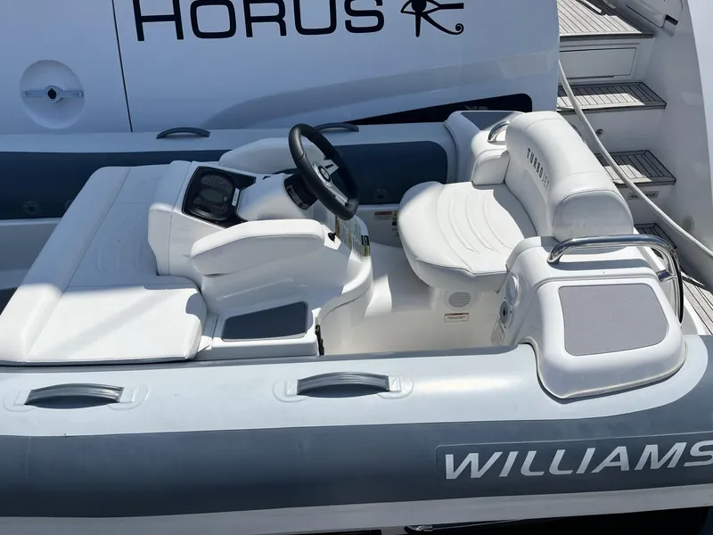 Slide: The Image of 2021 Williams Jet Tenders Turbojet 325, sleek white design, luxury seating, and modern controls. - 5