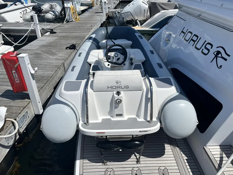 Slide: The Image of 2021 Williams Jet Tenders Turbojet 325 docked beside a yacht, featuring sleek design. - 6