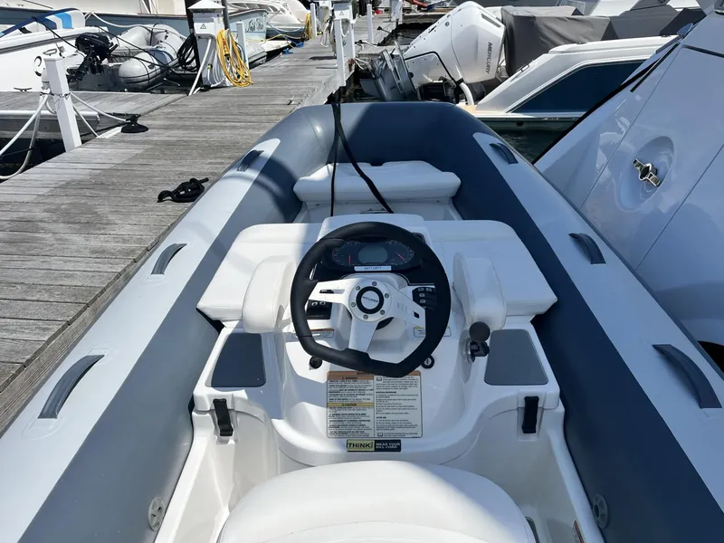 Slide: The Image of 2021 Williams Jet Tenders Turbojet 325 at dock, featuring steering console and seating. - 8