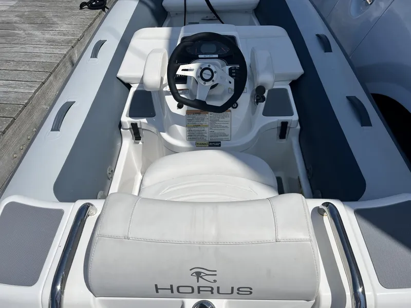 Slide: The Image of 2021 Williams Jet Tenders Turbojet 325 interior with steering wheel and seating. - 9