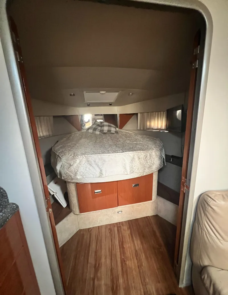 Slide: The Image of Luxurious interior of a 2006 Formula 40 PC yacht with leather seating and wooden table. - 30