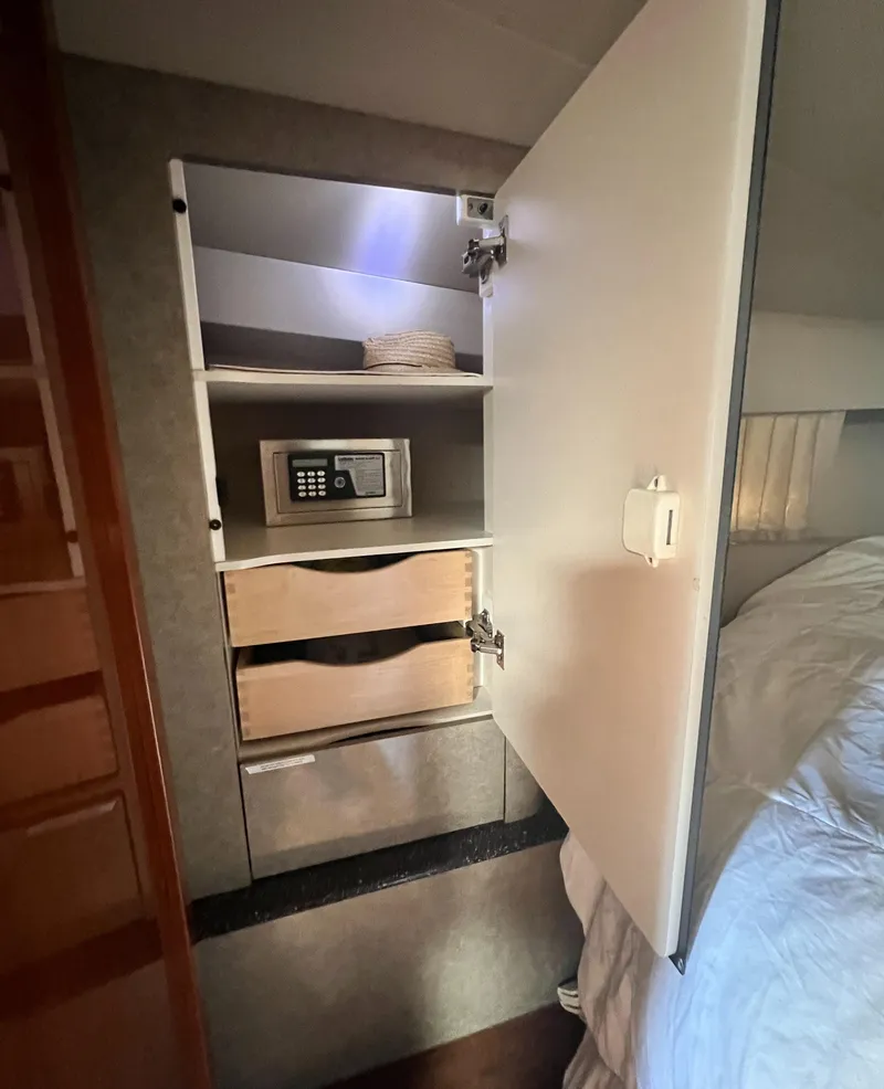 Slide: The Image of Interior cabin of a 2006 Formula 40 PC yacht with a cozy bed and wooden storage. - 33