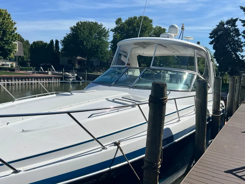 Slide: The Image of 2006 Formula 40 PC yacht docked in a marina, featuring a sleek blue and white design. - 7
