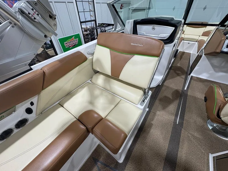 Slide: The Image of 2016 MasterCraft X26 boat interior with brown and cream seating. - 15