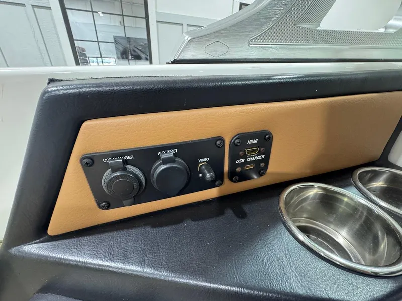 Slide: The Image of 2016 MasterCraft X26 dashboard with USB, HDMI ports, and cup holders. - 18