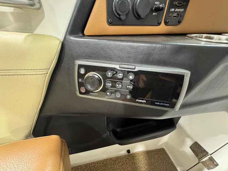Slide: The Image of Control panel of a 2016 MasterCraft X26 boat featuring a Fusion MS-IP700i audio system. - 19
