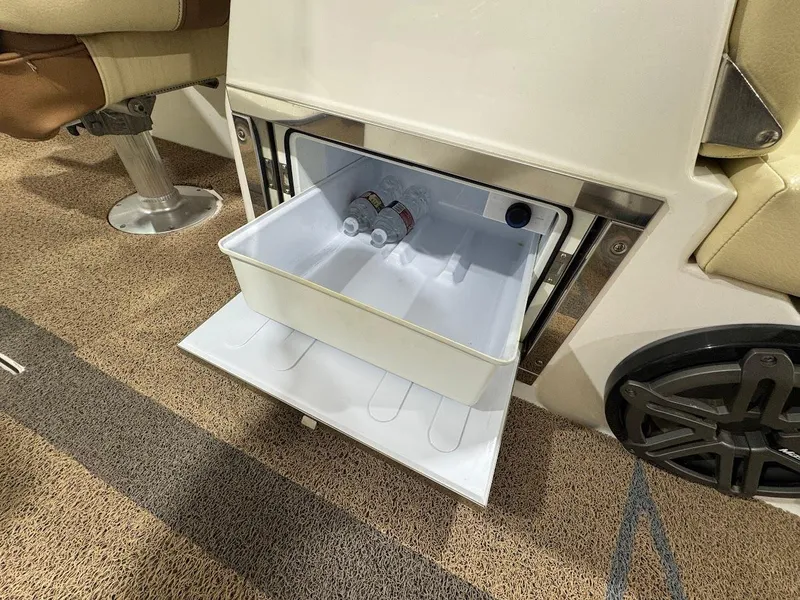 Slide: The Image of 2016 MasterCraft X26 boat interior with open cooler drawer containing bottled drinks. - 22