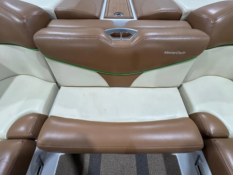 Slide: The Image of 2016 MasterCraft X26 boat interior with brown and cream leather seating. - 25