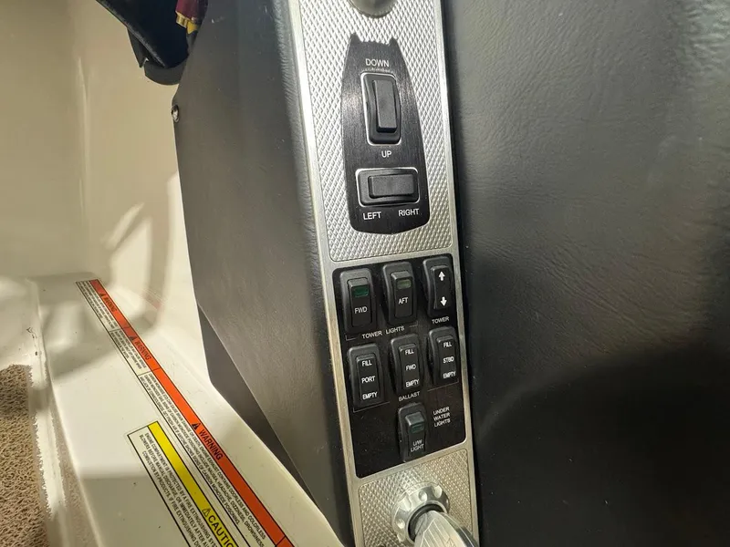 Slide: The Image of Control panel of a 2016 MasterCraft X26 boat with various switches and buttons. - 31