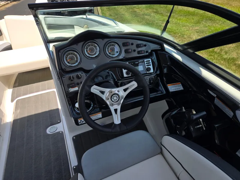Slide: The Image of 2013 Yamaha Boats 212SS dashboard with steering wheel and control panel. - 12