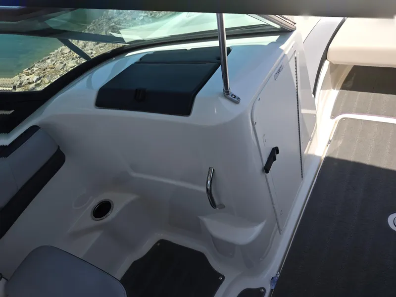 Slide: The Image of Interior view of a 2013 Yamaha Boats 212SS, showcasing seating and storage area. - 13