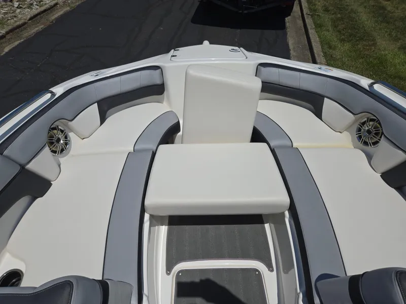 Slide: The Image of 2013 Yamaha Boats 212SS interior with gray and white seating, featuring built-in speakers. - 16