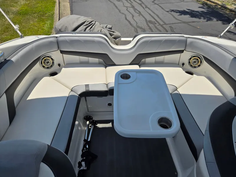 Slide: The Image of 2013 Yamaha Boats 212SS interior with seating and table, featuring cup holders and speakers. - 21