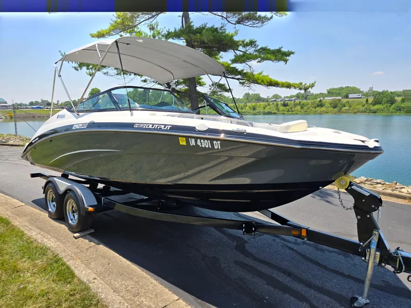 Slide: The Image of 2013 Yamaha Boats 212SS on trailer by a lakeside road. - 8