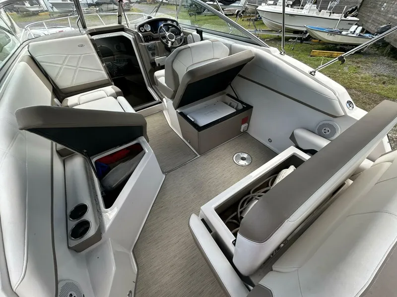 Slide: The Image of 2017 Regal 26 Express boat interior with seating, storage compartments, and steering wheel. - 10