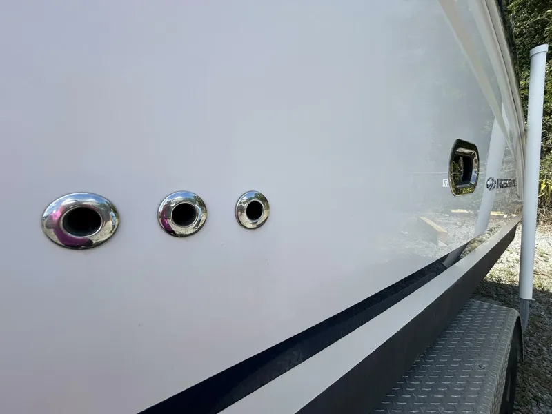 Slide: The Image of 2017 Regal 26 Express boat hull with chrome fittings and logo. - 12