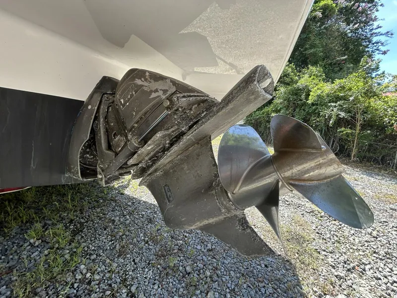 Slide: The Image of 2017 Regal 26 Express boat propeller and stern drive on gravel surface. - 13