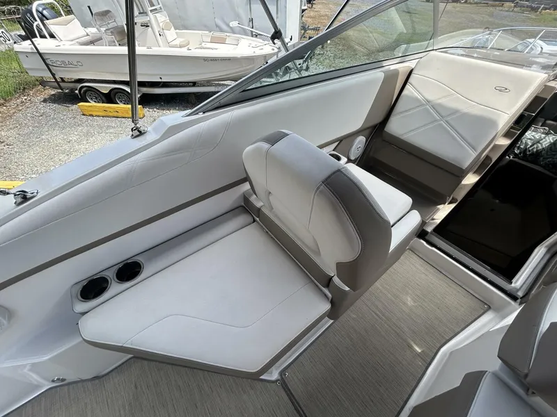 Slide: The Image of 2017 Regal 26 Express boat interior with white seating and cup holders. - 21