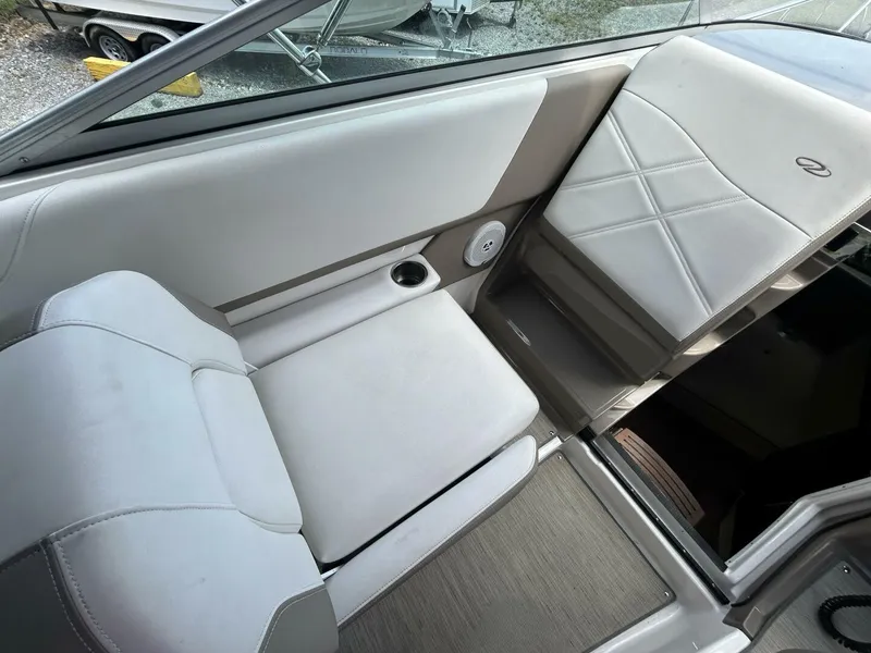 Slide: The Image of 2017 Regal 26 Express boat interior with cushioned seating and cup holder. - 22