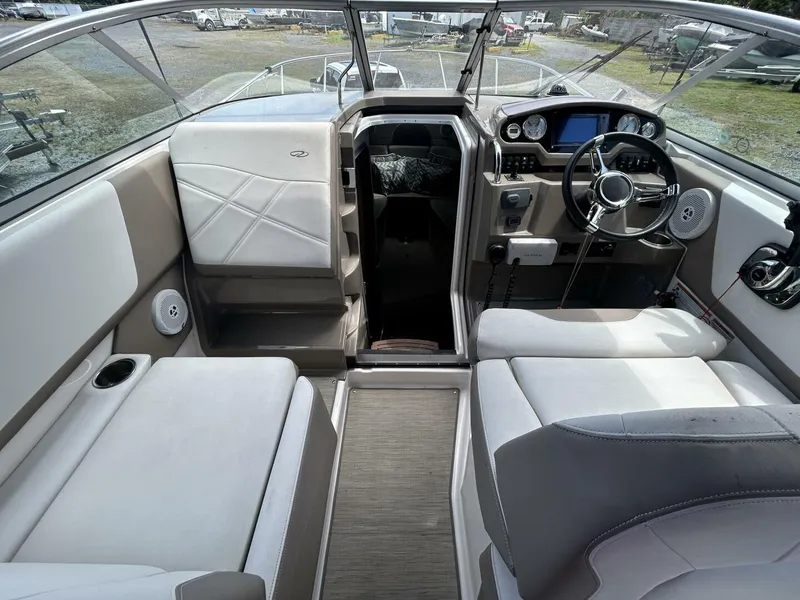 Slide: The Image of Interior of a 2017 Regal 26 Express boat, featuring modern seating and dashboard. - 23