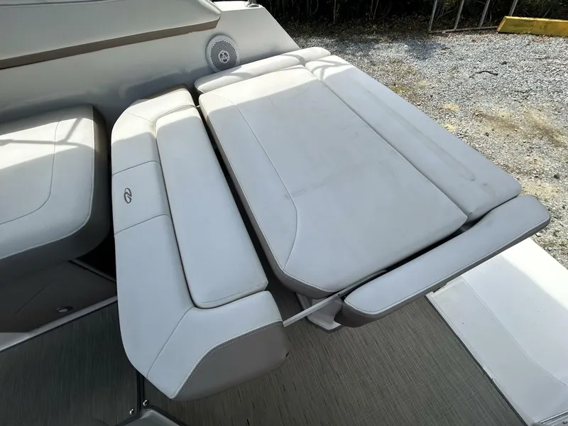 Slide: The Image of 2017 Regal 26 Express boat interior seating, featuring adjustable white leather upholstery. - 26