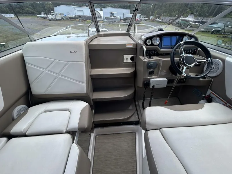 Slide: The Image of 2017 Regal 26 Express boat interior with steering wheel and seating area. - 28