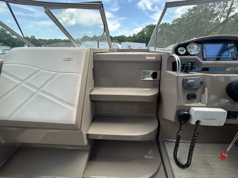 Slide: The Image of 2017 Regal 26 Express boat interior with helm, seating, and navigation equipment. - 31