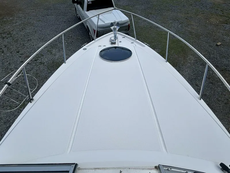 Slide: The Image of Bow view of 2017 Regal 26 Express boat with a white truck in the background. - 33