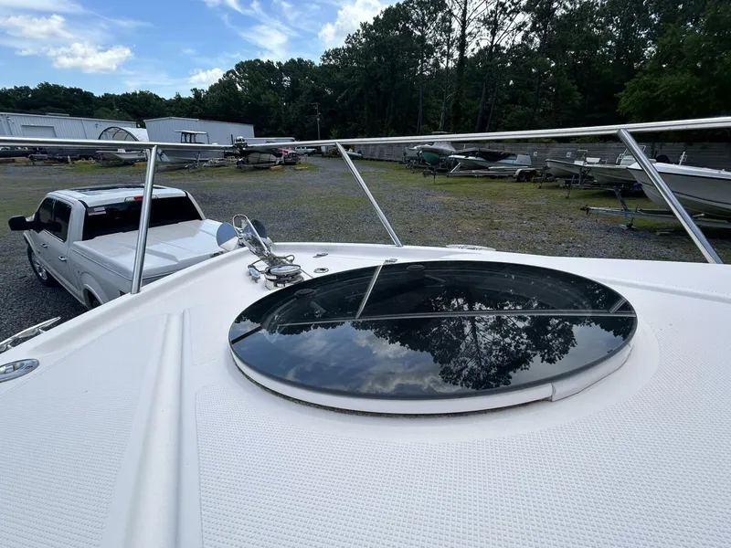 Slide: The Image of 2017 Regal 26 Express boat with sunroof, parked near a white truck. - 34