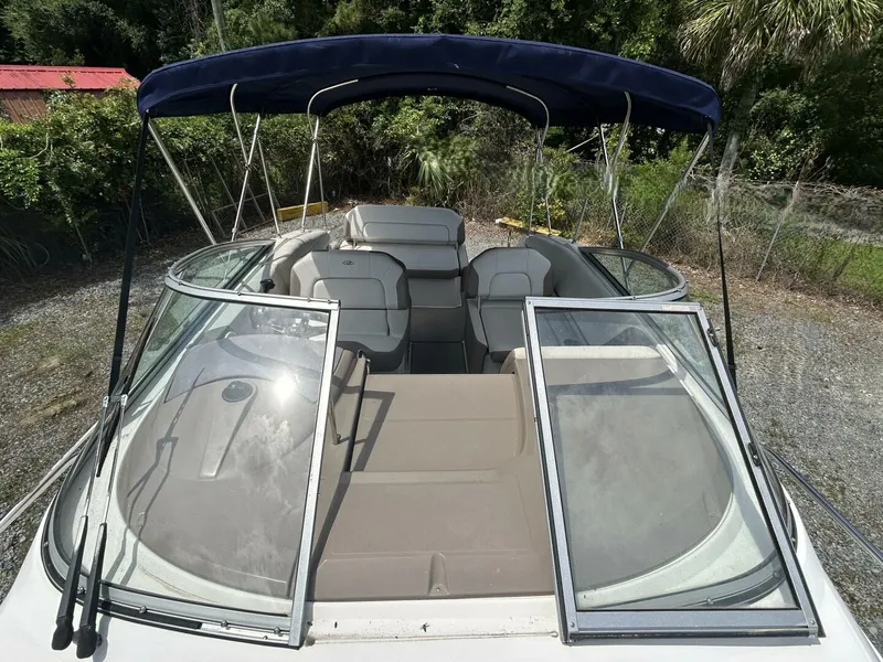 Slide: The Image of 2017 Regal 26 Express boat with open cockpit and blue canopy. - 36